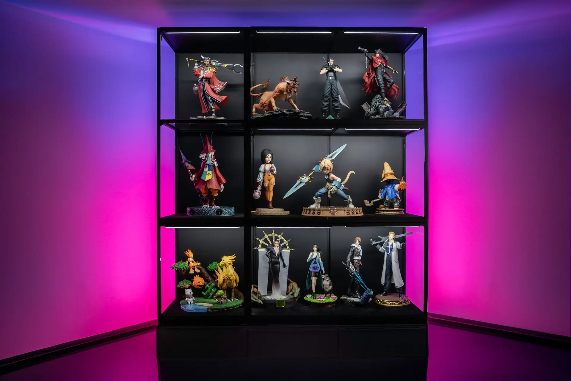 Large collectible statues displayed in lit Moducase display cases